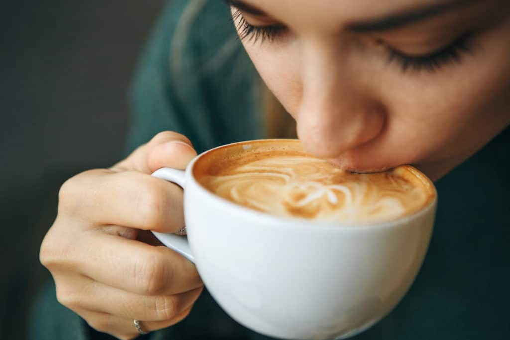 Close up girl is drinking coffee.