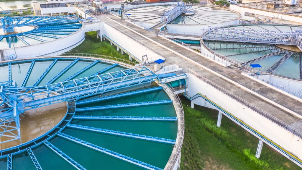 Aerial view of circular industrial water treatment tanks.