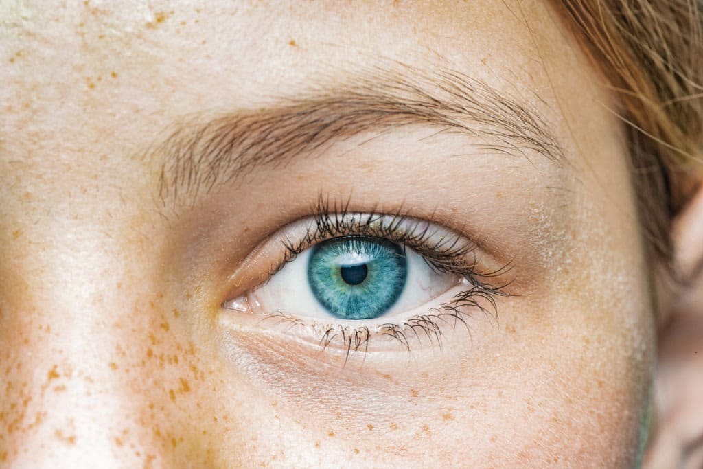 Human girl blue eyes close-up.